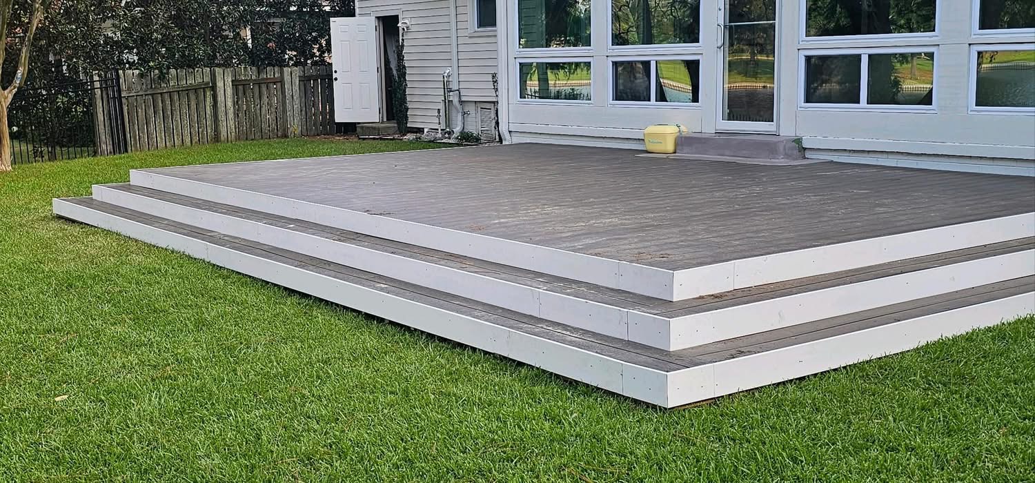 Low-profile ground-level deck with stepped border along the lawn